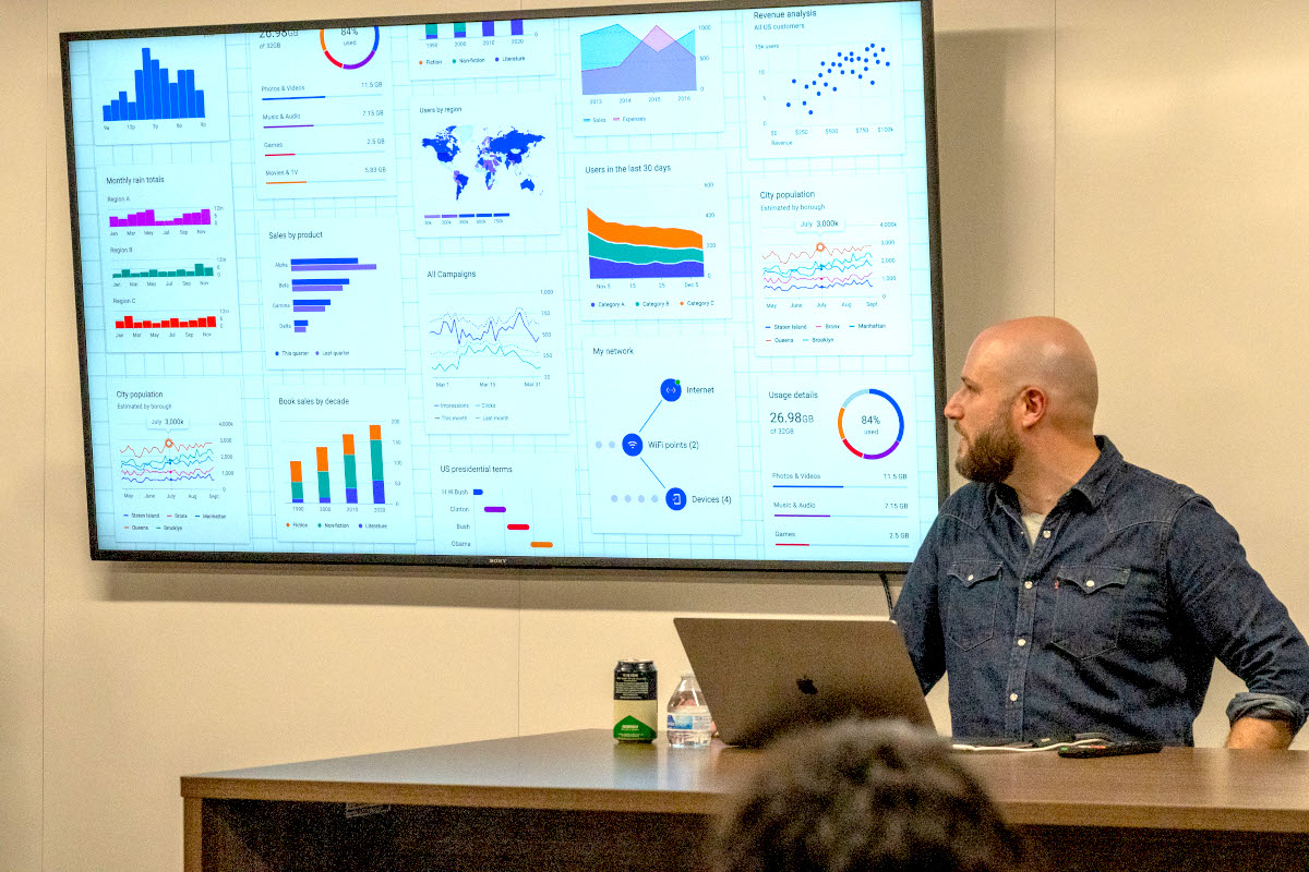 Kyle Bentle presenting on stage at an IxDA event